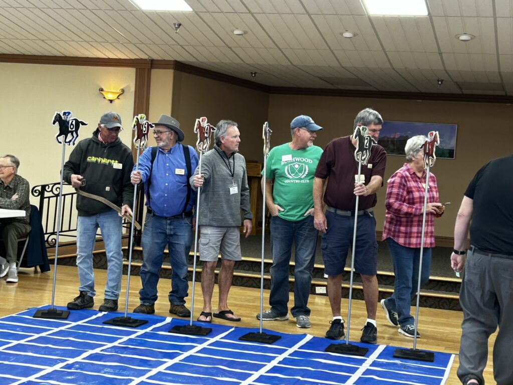 Residents with stick horses racing